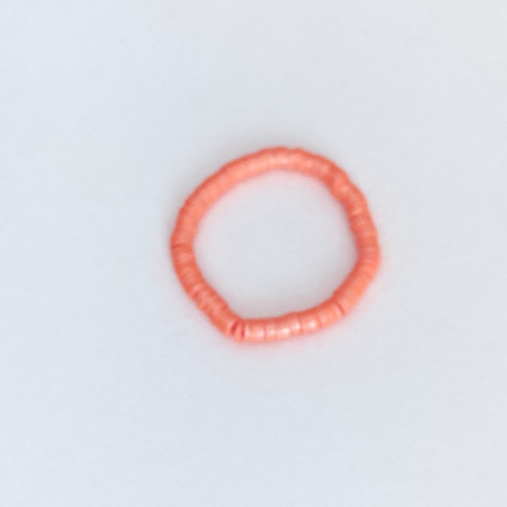 This is a shiny clay bead bracelet! Color- orange